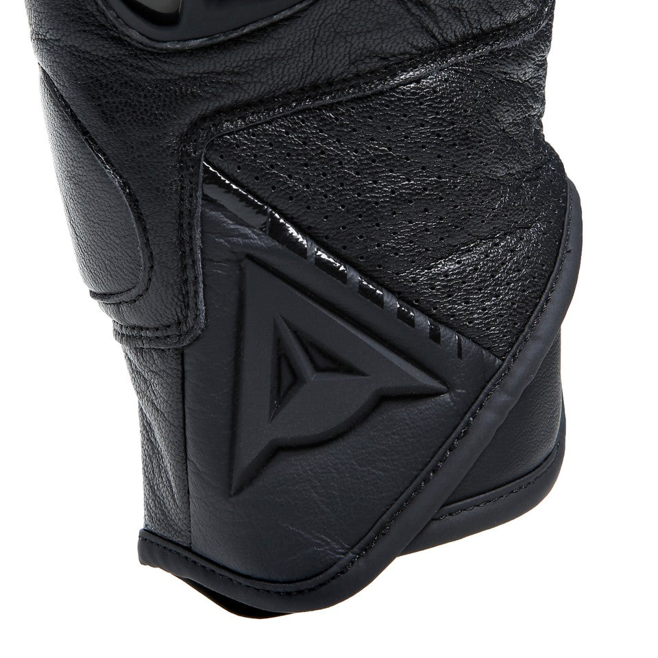 DAINESE BLACKSHAPE LEATHER GLOVES 黑/黑 袖口特寫，展示可調式魔鬼氈束帶與DAINESE三角浮雕標誌，穿孔區域提供良好透氣性，義大利原廠山羊皮革製短版復古手套